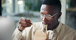Office, black man and computer with food for eating, working lunch or nutrition with content writer. Workplace, male person and business journalist with takeaway of noodles, hungry and tech for news 