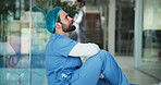 Upset, hallway and doctor in hospital with stress for patient loss, clinic mistake and medical crisis. Healthcare, surgeon and sad person on floor with burnout, frustrated and pressure for bad news