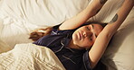 Stretching, above and wake up with woman in bedroom for sleeping, tired and morning routine. Relax, resting and wellness with female person lying in bed of home for energy, comfortable and health