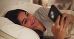 Bedroom, online dating and woman with smartphone, home and communication with contact on bed or app. Typing, message and person with mobile for chat, relax and tech for social media, night and house