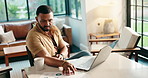 Documents, laptop and problem solving with freelance man in home office for financial report. Computer, reading and solution with remote work person in apartment for budget, finance or investment