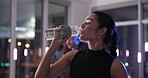 Active, woman and drink water in spin class at gym for rest, hydration and thirsty from exercise. Female person, breathe and bottle for refreshing liquid, intense workout or break of cycling recovery