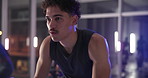 Cycling, class and man in gym on machine for cardio workout, exercise and training for strength. Sports, health club and people on stationary bike for endurance, fitness and challenge for wellness