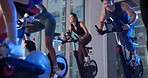 Spinning class, fitness and people in gym for cardio workout, health or leg muscle training. Wellness, activity and group of athletes on bicycle machine for cycling exercise in sports center at night
