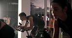 Athlete group, bike and fitness in spin class for cardiovascular improvement or cycling at night. Exercise, performance and stationary spinning with intense people in gym for late evening challenge