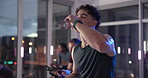 Athlete, man and drink water on stationary bike at gym for rest, hydration and thirsty from exercise. Tired, person and machine for refreshing liquid, intense workout and break for cycling recovery