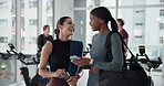 Fitness, friends and women in gym with phone, social media and laugh with conversation or funny meme. Networking app, smile and people in wellness center with tech, communication or workout website