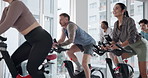 Fitness, indoor cycling and group workout with trainer for cardio, endurance challenge and laugh. Stationary bike, training and people in class for body health, exercise or sports with energy in gym