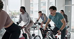 Class, indoor cycling and people exercise for fitness, burn calories and lose weight for body health. Gym, group and stationary bike for cardio training, workout and leg strength for muscle wellness