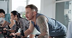 Fitness, indoor cycling and people in gym for cardio exercise, endurance challenge or training. Group workout, spin class and stationary bike with athletes in health club for performance or sports