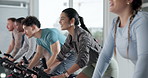 Happy people, instructor or fitness with bicycle for spin class for group exercise or workout at gym. Active, team or community cycling with coach or personal trainer for cardio, health or wellness