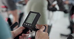Monitor, cycling and health with hands in gym for training, elliptical machine stats and cardio. Wellness, speed tracking and exercise with people on stationary bike in sports center for spin class