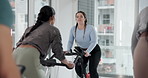 Cycling, fitness and personal trainer in spin class for cardio training, challenge or performance. Exercise, instructions and routine with woman coach in gym for endurance workout on stationary bike
