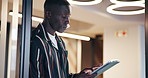 Black man, tablet and reading feedback in office with scroll, contact or check notification for deadline. African person, tech and app with overtime, project planning or review at creative agency