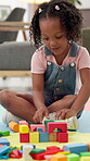 Building blocks, development and growth with girl in office for cognitive or problem solving skills. Creative, education and puzzle with child student on classroom floor for game, study or therapy