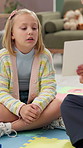 Child psychologist, girl and card for evaluation with reading, guide or test for learning disability. Therapy, kid and paper with consulting, assessment and exam for help with mental health on floor