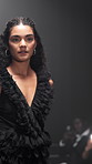 Girl, runway and model for fashion week, show or dress for design, confident or style at expo. Woman, couture clothes and stage in evening gown on catwalk, gloves or collection for audience at event