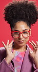 Face, woman and earrings for fashion in studio with confidence, glasses and trendy clothes. Portrait, African female person and proud with jewellery, stylish outfit and accessories on red background