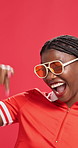 Excited, pointing or face of black woman in studio for winning store discount, sale or bargain. Happy, yes and portrait of African person in sunglasses, trendy style or cool fashion on red background