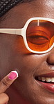 Black woman, skincare and cream in studio, sunglasses or smile in closeup with face by background. African girl, lotion and moisturizer for glow with shades, fashion and happy for benefits in Nigeria