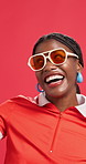 Happy, dance and face of black woman in studio for winning a store discount, sale and bargain. Excited, yes and portrait of person in sunglasses, style and reaction for fashion news on red background