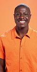 Happy, black man and face with fashion in studio for style or confidence on a orange background. Portrait, male person or African model with smile, tshirt or positive attitude for casual clothing