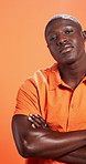 Studio, face and man with arms crossed, fashion and pride with stylish clothes or orange background. Confident, trendsetter and black person with unique outfit, trendy and model with tshirt in Kenya