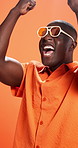 Black man, fist pump and success in studio with sunglasses, fashion and goals by background. African person, happy and excited with celebration, trendy style and winner with scream for giveaway prize