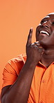 Thinking, pointing up or black man in studio with space, solution or lightbulb moment. Eureka, mockup or happy African model on orange background with inspiration, perspective or creative thought