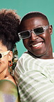 African couple, sunglasses and happy with arms crossed in studio, fashion or confident by background. People, woman and man with trendy clothes, laugh and smile with back for pride in relationship