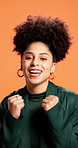 Face, cheering and woman in studio, celebration and achievement on orange background. Portrait, happy person and model with hand gesture, winning and success with bonus, giveaway and victory
