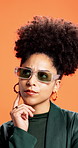 Thinking, glasses and woman in studio, wonder and stylish outfit on orange background. Person, planning and model with choice, contemplation and problem solving with solution, wonder and decision