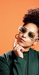 Thinking, sunglasses and woman in studio, decision and stylish outfit on orange background. Person, shades and model with choice, contemplation and problem solving with solution, wonder and planning