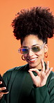 Woman, ok sign and happy with phone in studio with sunglasses, texting and good service by background. African person, smile and smartphone on mobile app, deal or choice for network with social media