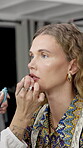 Hands, model or woman with lipstick backstage for beauty, production glamour or makeup preparation. Cosmetics, artist and lip gloss on set for photoshoot, magazine editorial and getting ready to film