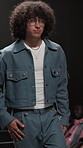Fashion week, man and walking on runway at event for clothes showcase, couture or designer brand. Catwalk show, audience and model with expensive wardrobe on stage for garment collection and menswear