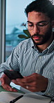Man, texting and smartphone for communication in office, network and chat on social media and night. Working late, employee and person with mobile for schedule, app and message for contact on website