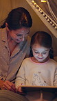 Tablet, tent and mother with child at night in home with bonding, family time or searching for movie. Happy, relax and mom with girl kid for playing educational game on digital technology together.