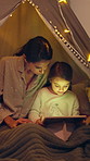 Tablet, tent and mother with kid at night in home with bonding, family time or streaming movie. Happy, relax and mom with girl child for watching film, show or series on digital technology together.