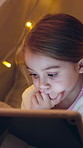 Tablet, relax and child in tent at night with searching for movie, film or show online in home. Digital technology, calm and girl kid playing educational game on app in blanket fort at house.