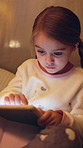 Girl, kid and learning with tablet at night for interaction, entertainment or childhood in bedroom. Child, browsing and playing on technology, UI or UX in late evening for online development at house