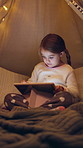 Girl, child and learning with tablet at night for interaction, entertainment or childhood in bedroom. Kid, browsing and playing on technology, UI or UX in late evening for online development at house
