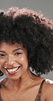 Face, smile and afro with black woman in studio for curl pattern, natural texture and growth. Shampoo cosmetics, volume and glow with person on gray background for salon treatment, beauty and shine