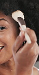Beauty, face and African woman with makeup brush in studio for makeover or cosmetics application. Facial, product and smile of happy model with tool for aesthetic, blending foundation or contour