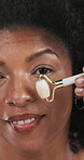 Skincare, face roller and black woman with cosmetic, natural and lymphatic drainage treatment. Portrait, dermatology and African female person with beauty tool for routine of facial blood circulation