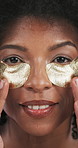 Skincare, eye patches and face of black woman with beauty, hydration or collagen routine. Gold mask, portrait and African female person with facial, dermatology or natural treatment for dark circles.
