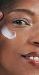 African woman, skincare and closeup with cream in studio, application and happy by background. Mature person, lotion and moisturizer with portrait, cosmetics and product for anti aging in Nigeria