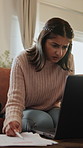 Finance, laptop and woman confused with documents on sofa for budget mistake, doubt or bills error. Financial planning, person or stress with invoice in home for bankruptcy, missed payments or crisis