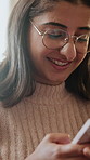 Woman, phone and laugh with texting in home, chat and happy with funny meme on web in living room. Person, smartphone and scroll with mobile app, video and comic post on social network at apartment