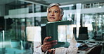 Employee, window and woman with tablet, thinking and online reading with application. Mature person, consultant and digital tech in workplace, internet and investment with problem solving and choice